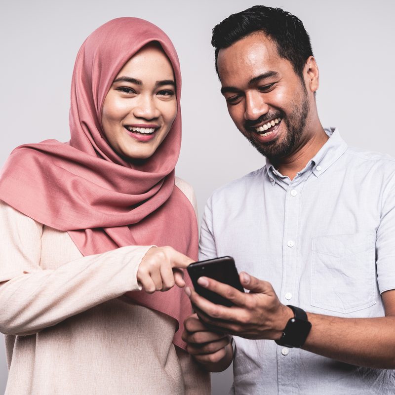 A couple receiving money on their phone